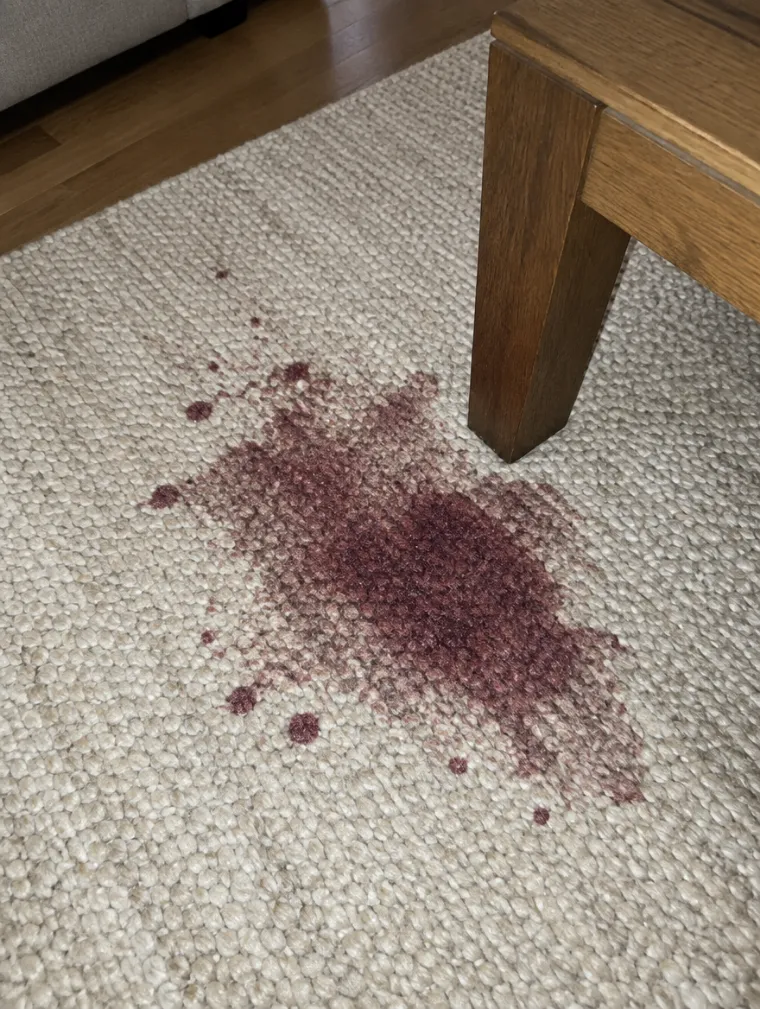 Red wine stain on a rug, photographed by the cleaner